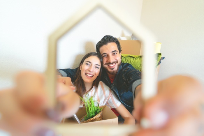 happy-young-couple-moving-in-new-home-first-time